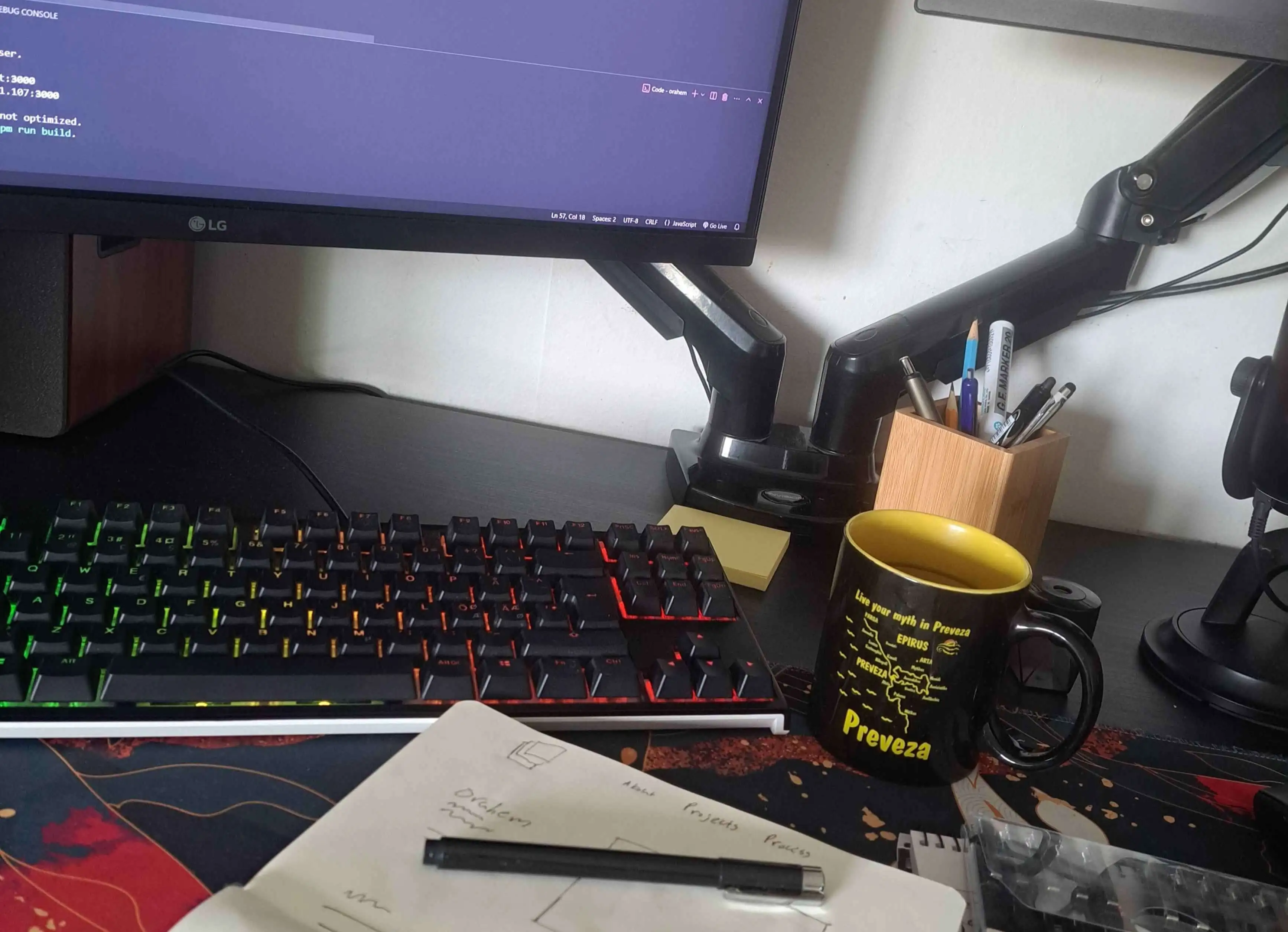 My desk, with a code editor open on the monitor